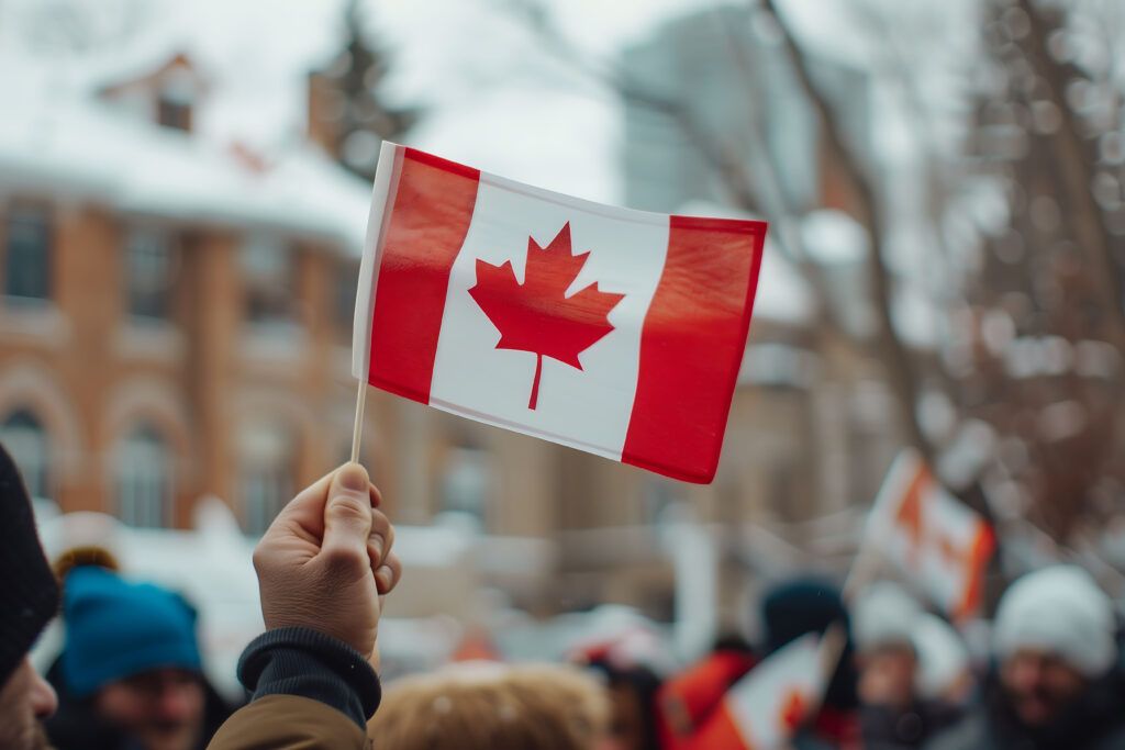 People waving Canadian flags during a celebration in Canada
